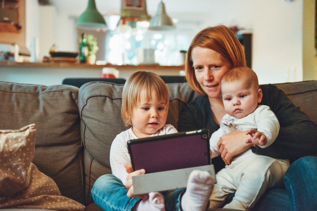 Parent and children using tablet together